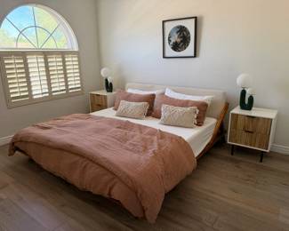 CB2 full-size bed frame, teak wood with cream material headboard.