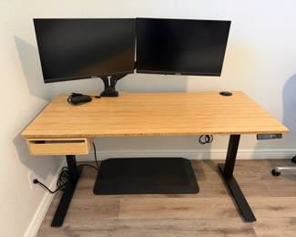 Fuly electic standing desk, teak wood look with black metal frame, drawer, 60" l x 27" w, range is 25" to 51" standing height, bought from Design Within Reach