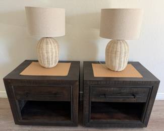 Two (2) Pottery Barn dark wood bedside tables, 27" l x 19" w x 24" h.  Two wicker lamps, in excellent working condition.