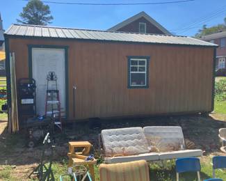12’ x 24’ shed with wood siding, roll top door, window, and side door. This shed is over $8000 new today.