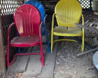 There are 4 of these colorful vintage metal patio chairs. I had to stop pulling them out because of a nest of something stinging in the ground. 