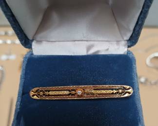 14k yellow gold antique pin with a diamond