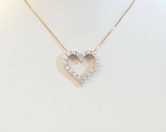 0.40 ct tw diamond heart pendant in yellow gold. 18" chain