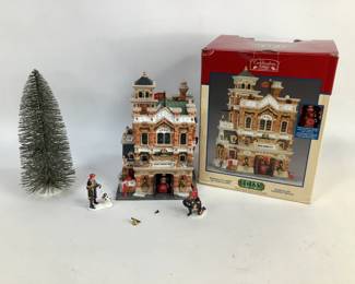 Christmas village house with tree and figurines