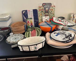 Assorted kitchenware, including melamine mixing bowl set with lids, glass cake plate and deviled egg plates, watermelon serving platter 