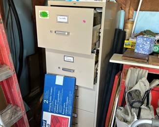 4 drawer file cabinet. Top two drawers are filled with hanging files & folders 
