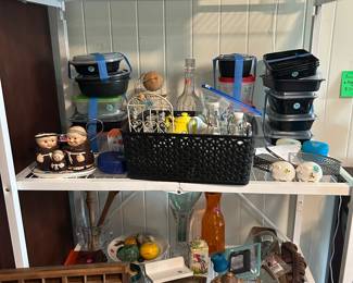 Miscellaneous food storage and housewares. Included are empty spice jars, pepper grinders, kitchen gadgets and antique wood printer tray