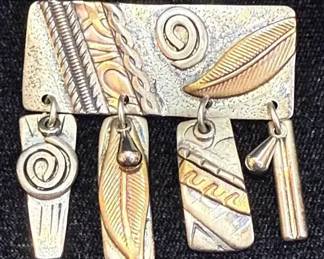 Multi Metal Pendant Featuring Feather and Spiral Motifs