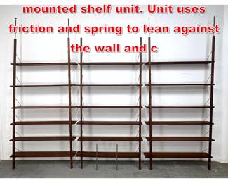 Lot 541 Vintage walnut wall mounted shelf unit. Unit uses friction and spring to lean against the wall and c