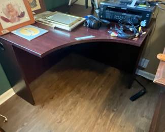 Corner desk in bedroom with pictures & electronics