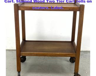 Lot 1000 HERBERT E GIBBS Rolling Serving Cart. Stained Wood Two Tier Cart rolls on casters. Label.