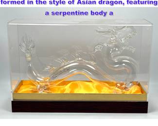 Lot 700 Clear glass decanter, intricately formed in the style of Asian dragon, featuring a serpentine body a