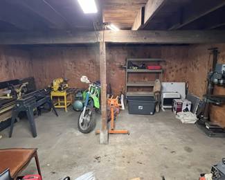 Lathe, Craftsman planer, Kawasaki bike, engine stand, Milwaukee dust collector unused in case, industrial drill press, chevy transmission, tile, shelf, propane heater, ceiling fan light, painters drop cloth, and more.