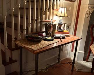 Neo classical marble top table  with iron base.  1960’s and 70’s 45’ records   Silver plate water pitcher and ash waste gatherer 