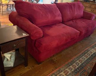 Scarlet upholstered sofa
 in good condition.   Small end table 
