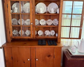 A very nice size- two piece- pine cupboard.
Interior contains a set of Wedgwood china - Hedge Rose pattern. 
Some cast iron and painted tray. Two tin candle molds. 