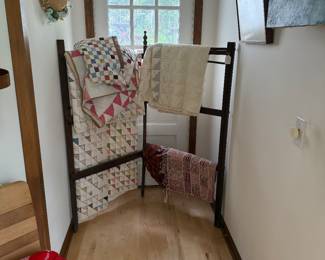 Early quilt rack and quilts. More upstairs in bedrooms. 