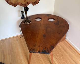 A unique repurposing of a blacksmith’s bellows section into a side table. 
Also, a candlestick, brass telephone converted to a lamp. 