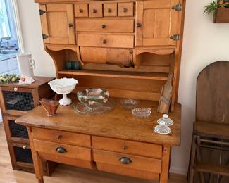 Baker’s cabinet. Two left is a three sectioned screened type pie safe. More collectibles and mid century era glasses. 