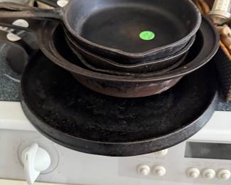 Group of cast iron cooking pans , some Wagner. 