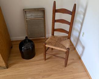 A sweet child’s ladder back chair. A brown jug with “Anderson” written on it. Plus a well used washboard. 