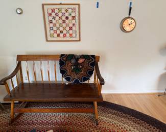 “mammies” rocking bench.  Early hooked rug. Needlework framed art. Mark Craft clock on a revere ware pan. 