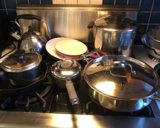 Pots & pans including no-name No. 8 cast iron skillet, Calphalon 5.5 qt. sauté pan with lid, Revere Ware stock pot, tea kettle