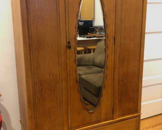 Antique oak armoire with oval mirror & drawer at bottom (46.5”W, 17”D, 77”H) 