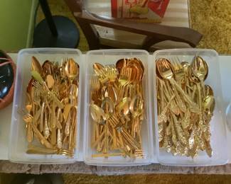 Three different gold tone flatware patterns