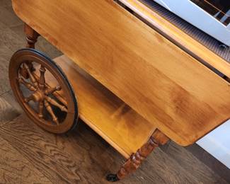 A Tea Cart with Wagon Wheels with Fold Out Leaves. 