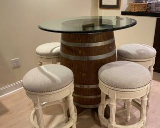 Repurposed wine barrel with glass top and 5 café height swivel stools from frontgate