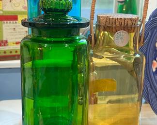 Incredible Collection of Takahashi Hand Blown Glass Jars Including an Amber Glass Hand Blown Jar with Rattan Handle & Cork Plug 9", an 11" Green Art Glass Jar and 14" Blue Glass Jar.