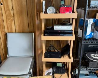 Chairs, crates, shelf, routers, phones, barometer, cd players, vintage type writers, vintage stereo players with speakers