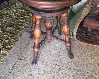 Claw leg piano stool.