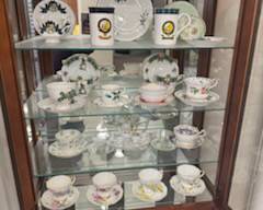 Curio Cabinet is available. Contents are sold separately (Fine china cups and saucer sets)