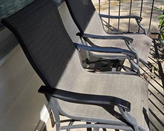 Two slingback patio chairs.  Swivel and rock.