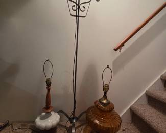 Left to right...white glass and maple wood.  Middle, very tall black iron and faux electric candlesticks (Spanish or Gothic looking)
Right, vintage amber glass base with antique bronze metal.