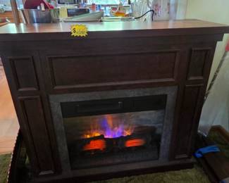 Infrared electric fireplace with remote.  Economical to run, nice to look at.  Warms up to 200sq feet nicely.  Three scratches on top.