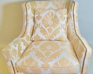 2 Harden Upholstered accent chairs with damask pattern fabric in gold/cream colorway, brass nailhead trim and turned wooden feet.