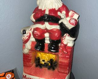 vintage Dapol Industries blow mold decoration featuring Santa Claus sitting on a chimney fireplace. 
