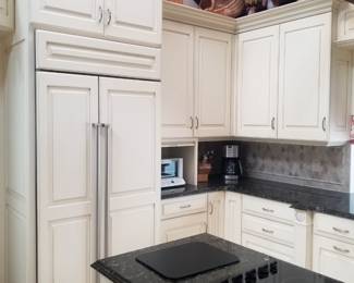 Sub-Zero refrigerator; kitchen island with JennAir cooktop