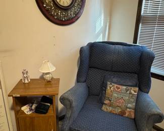 Wingback chair, side table, decorative clock, throw pillows