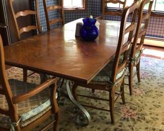 Table w/ 1 leaf, 6 chairs with rush seats & 2 with arms. Metal legs. Aubusson rug 99” x 118”.