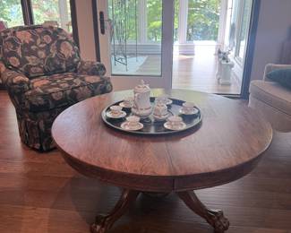 solid oak, antique dining table has been cut down to the size of a large round coffee table