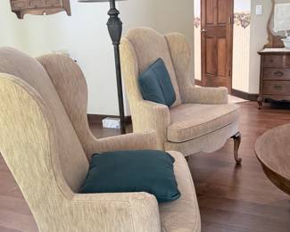pair of Ethan Allen wing back chairs covered in a soft neutral velvet fabric