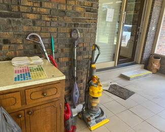 Cabinet perfect for shop, Dyson vacuum, shark steam mops
