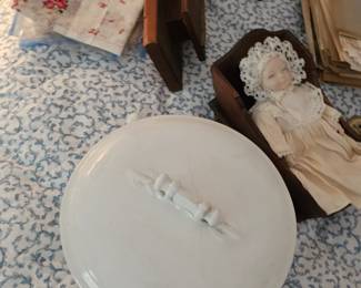 White Covered Pot, Small Doll In Cradle, Small Dish, Handkerchief
