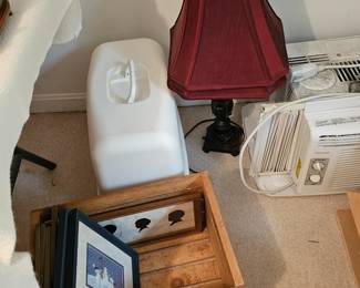 Table Lamp with Red Shade, Window Air Conditioner, Assorted Framed Pictures