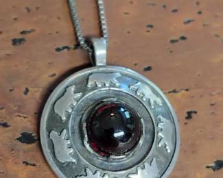 Dancing bear necklace with large garnet.