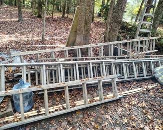 Lots of aluminum ladders and roofing tools.